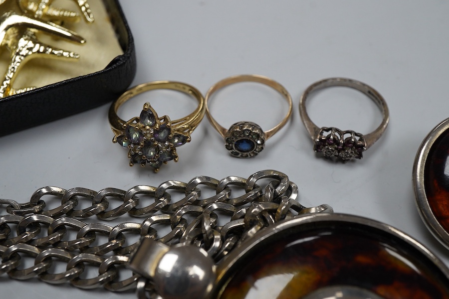 A collection of jewels, comprising: a coated topaz cluster ring in gold, stamped 9ct; a synthetic sapphire and colourless paste cluster ring in gold, stamped 9CT; an amethyst and colourless paste ring in silver, British